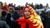 KYRGYZSTAN -- A demonstrator wearing the national flag gestures during a protest against the results of a parliamentary election in Bishkek, October 6, 2020