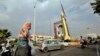 IRAN -- An Iranian woman wearing a face mask walks past as a Ghadr-H surface-to-surface missile on display in a street exhibition by Iran's army and paramilitary Revolutionary Guard celebrating 'Defense Week' marking the 40th anniversary of the start of 1