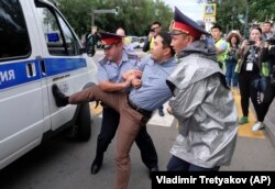 Полиция наразылық митингісіне шыққандарды көлікке күштеп салып жатыр. .Алматы, 12 маусым 2019 жыл.