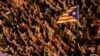 SPAIN -- People raise arms and shout during a demonstration two days after the banned independence referendum in Barcelona, Spain, October 3, 2017