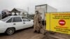 KAZAKHSTAN -- Police officers wearing a protective gear are seen at a checkpoint set up to lock down the city to prevent the spread of the COVID-19 coronavirus disease, on the outskirts of Almaty, March 23, 2020