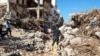 Members of Libyan Red Crescent Ajdabiya work in an area affected by flooding, in Derna