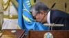 Kazakhstan - Acting President of Kazakhstan Kassym-Jomart Tokayev kisses a flag as he takes part in a swearing-in ceremony during a joint session of the houses of parliament in Astana, Kazakhstan March 20, 2019. Kazakh Presidential Press Service/Handout v